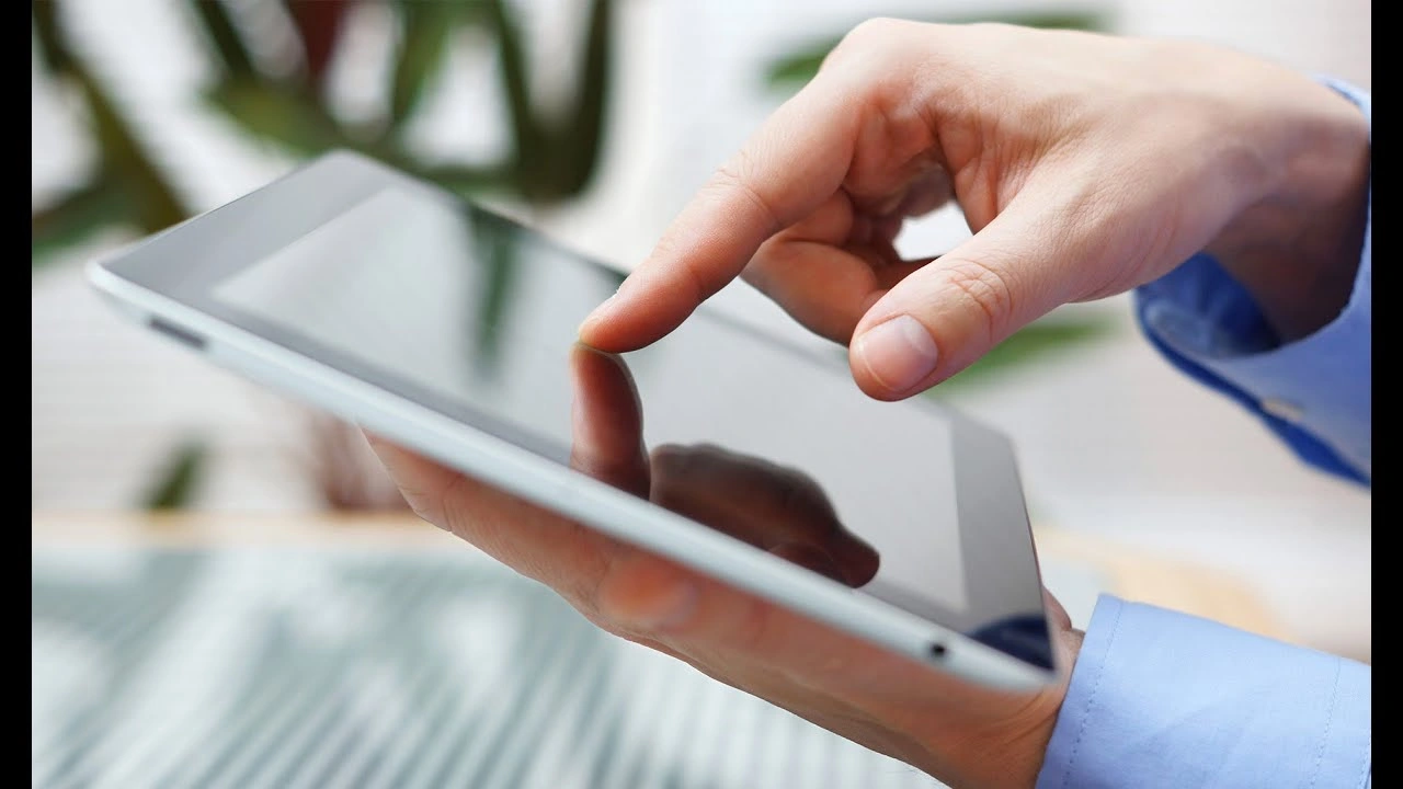 a person holding a tablet maxresdefault